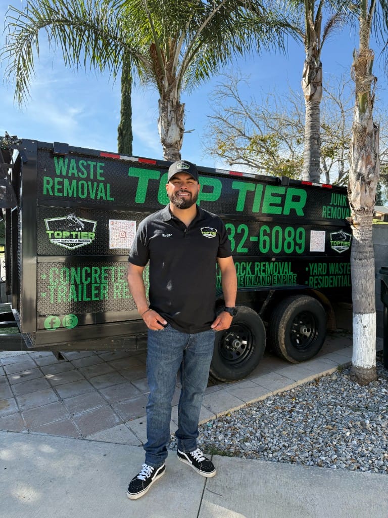 Top Tier Junk Removal crew with branded trailer and equipment on site